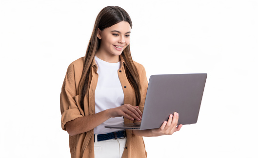 happy teen school girl has education with laptop isolated on white background. school girl use laptop for education. teen girl with pc for school education in studio. school education for girl.