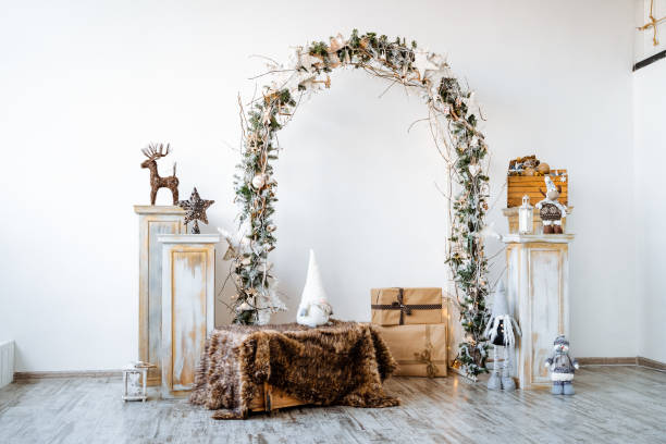 istock Arch on a white background decorated with spruce branches and a garland, new year's composition in the interior, a zone for a photo shoot in the Studio, room decor for Christmas 1773062220