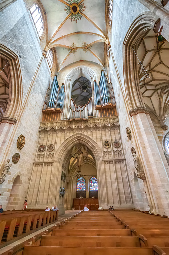 Ulm, Germany - July 20, 2019:  Big church organ pipes, Interior of the Ulm Cathedral the tallest church in the world.