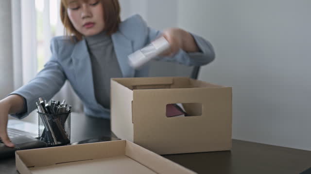 Resignation concept.Businesswomen packing Stuff with cardboard box for quit a job.