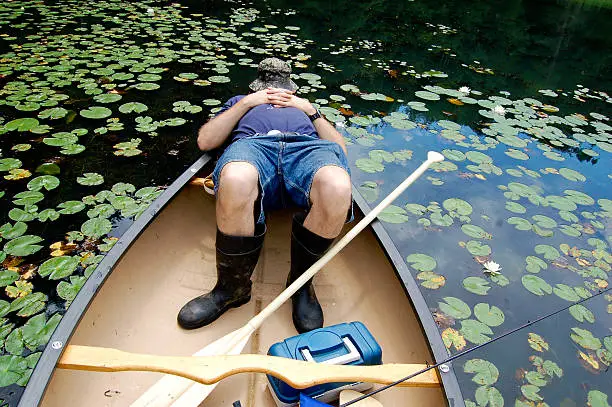Photo of Fisherman asleep in his canoe