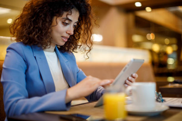istock Businesswoman using digital tablet at hotel restaurant 1773071949