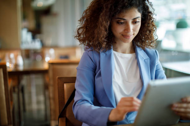 istock Businesswoman using digital tablet at hotel cafe 1773071981