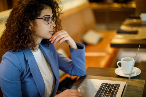 istock Thoughtful businesswoman looking away and thinking of problem solution at a cafe 1773073539