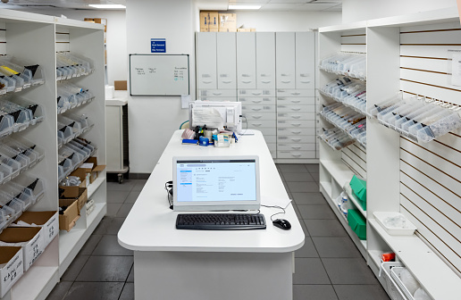 Hospital pharmacy full of medicines with no people - healthcare and medicine concepts