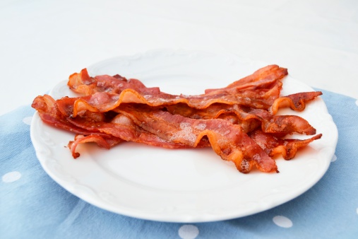Fried bacon on a white plate 