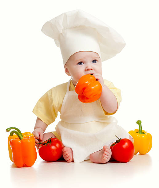 istock baby wearing a chef hat with healthy  food vegetables 177308564