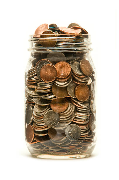 istock Glass jar overflowing with American coins 177308741