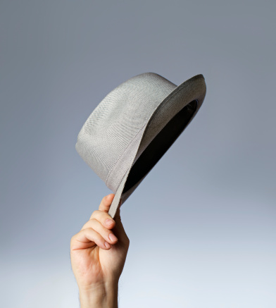 Man tipping his vintage trilby hat.