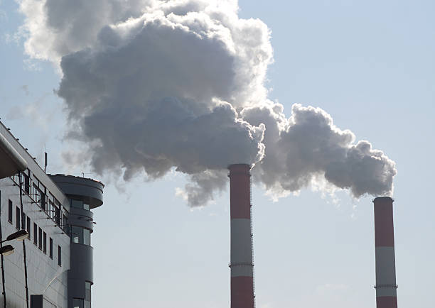 istock Two tubes with thick smoke and part of building 177311024