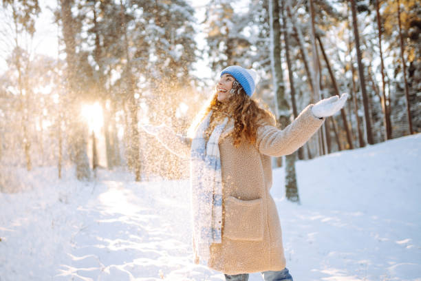istock A young woman throws out snow. 1773120092