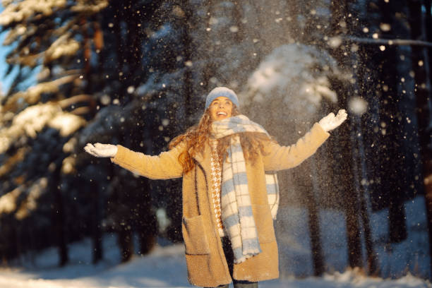 istock A young woman throws out snow. 1773120112