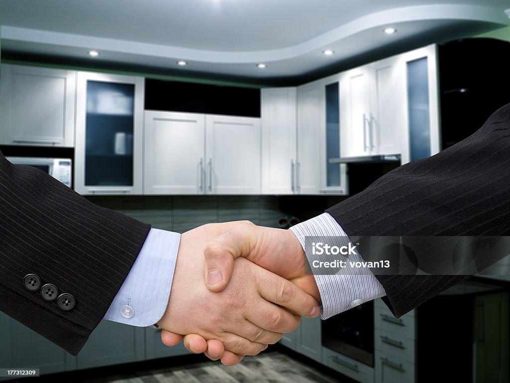 Handshake Handshake with modern skyscrapers as background Adult Stock Photo