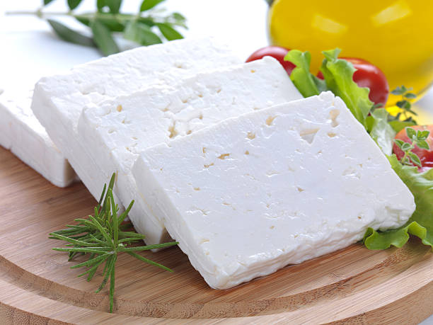 close up of feta slices "feta cheese cut in slices, vegetables, herbs and olive oil-the ingredients for a greek salad" white cheese stock pictures, royalty-free photos & images