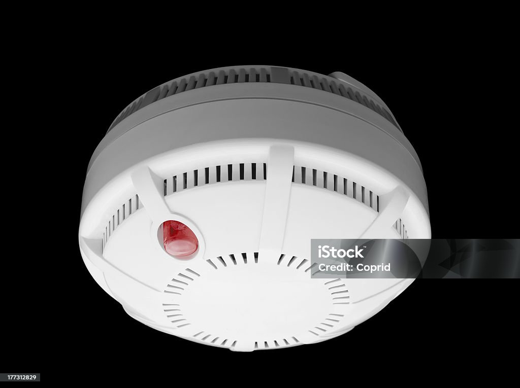 Smoke detector Smoke and fire detector part of fire alarm system isolated on black Smoke Detector Stock Photo