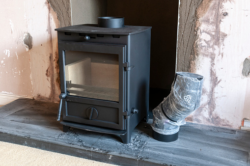 Woodburning multi-fuel stove being installed