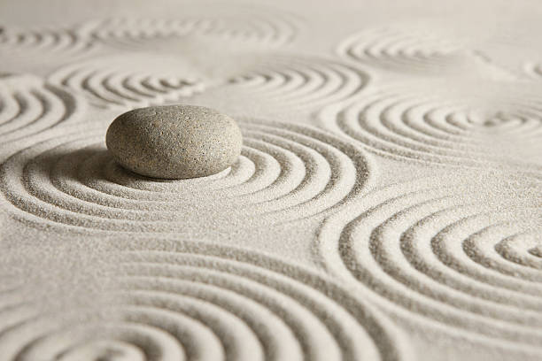 istock Zen garden Beige round stone on carefully arranged sand 177313418