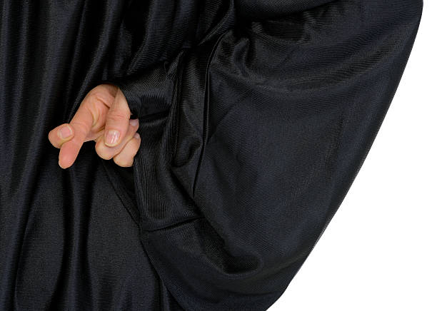 istock Close up on crossed fingers hidden behind back 177314031