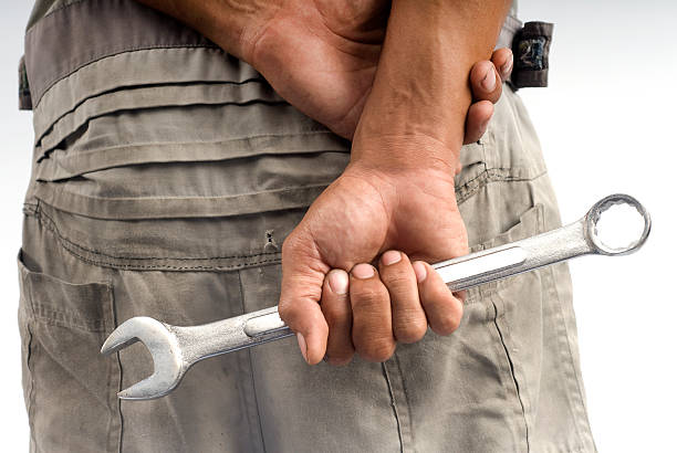 wrench in the mechanics hand.