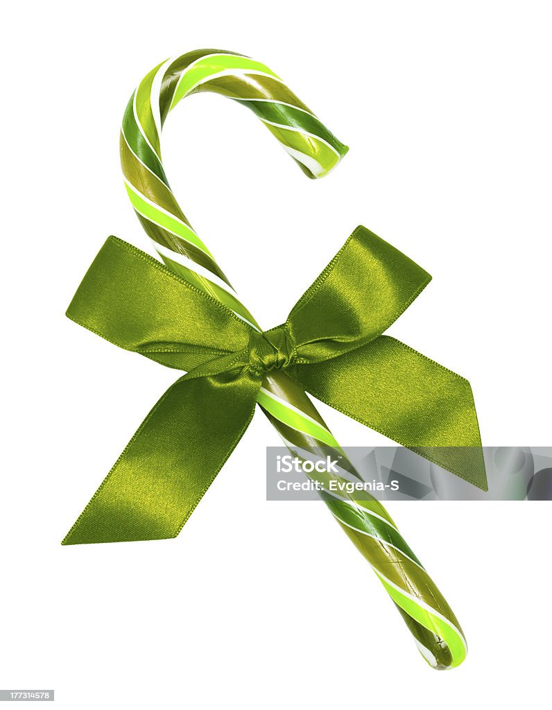 St patricks day candy cane with green bow isolated "St patricks day candy cane with green bow, isolated on white without shadow." Bright Stock Photo