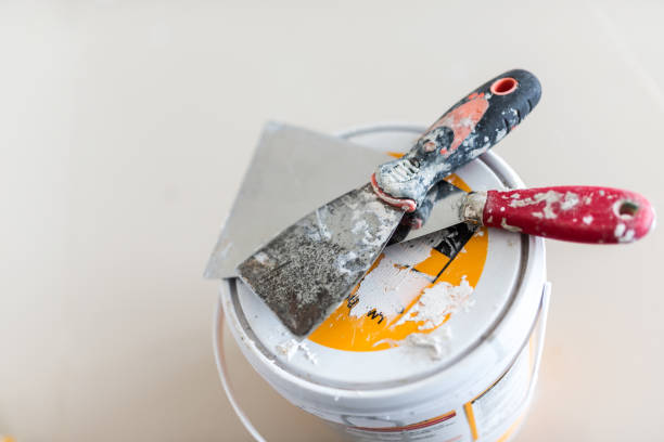 istock Cans of paint and trowel on a white background. 1773170230