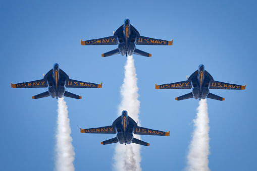 Tukwila, United States - July 28, 2014: This image shows four of the U.S Navy Flight Demonstration Squadron, the Blue Angels, flying in formation in Tukwila, Washington. The Blue Angels are in town for the 2014 Seafair festival.