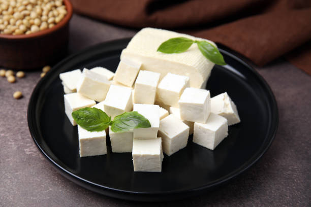 istock Delicious tofu cheese, basil and soybeans on brown textured table, closeup 1773171848