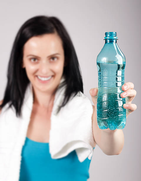 istock Smiling young woman promoting water 177317365