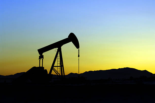 Oil Pumper at sunset stock photo