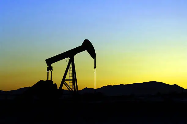 Oil Pump silhouetted against a mountain sunset