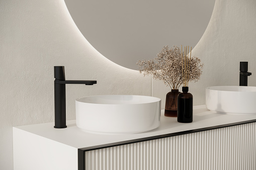 Close up of comfortable double sink with two round mirrors standing on wooden countertop in modern bathroom with white walls.