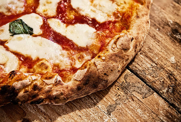 Pizza Margherita Italian Pizza Margherita on a rustic table. naples italy photos stock pictures, royalty-free photos & images
