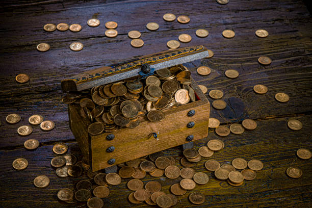 Treasure chest with gold coins over white background