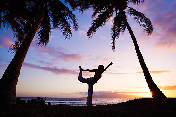 istock Woman Practicing Yoga at Sunset 177319440