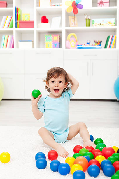istock Happy toddler with balls 177319546