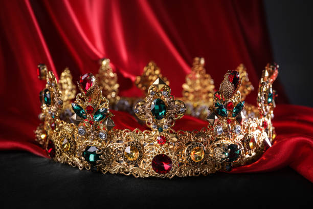 istock Beautiful golden crown with gems on black pillow 1773197902