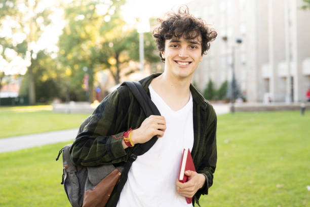 University student portrait in campus at sunset