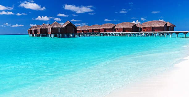 istock Overwater villas in blue tropical lagoon with white beach 177320550