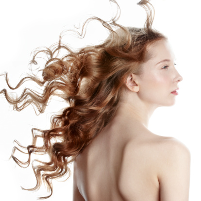 Woman with long curly hair on white