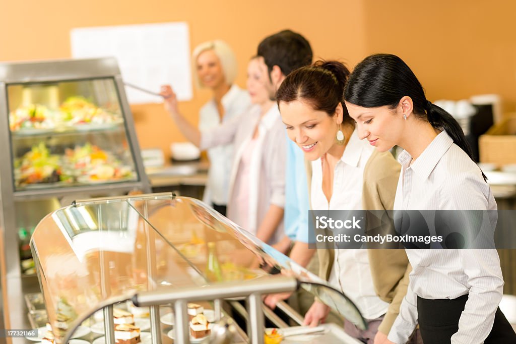 Cafeteria lunch two office woman choose food Cafeteria lunch two office colleagues woman choose food dessert self-service Food Bar Stock Photo