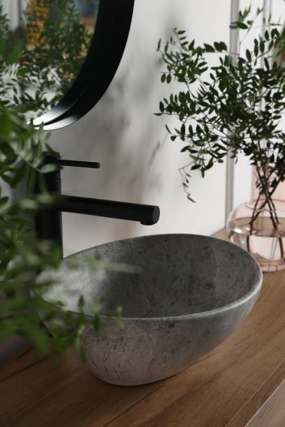 istock Eucalyptus branches near vessel sink on bathroom vanity. Interior design 1773213380