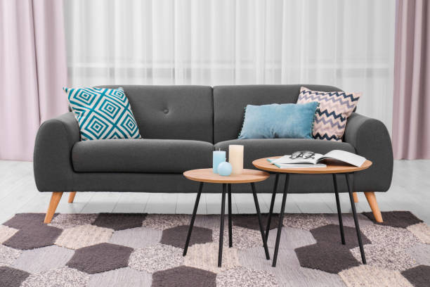 istock Comfortable sofa, floor lamp and coffee table in stylish room. Interior design 1773213915