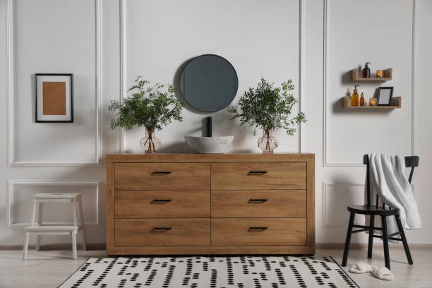 istock Modern bathroom interior with stylish mirror, eucalyptus branches, vessel sink and wooden vanity 1773214457