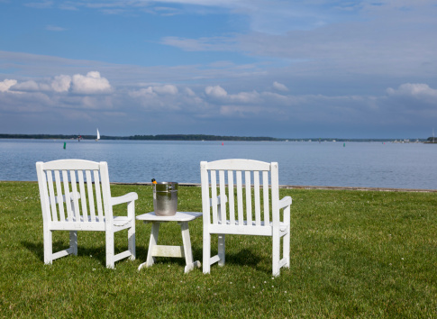 Empty patio chairs by side of the Chesapeake bay overlooking St Michaels harbor