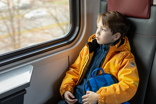 6 year old boy rides in a train carriage