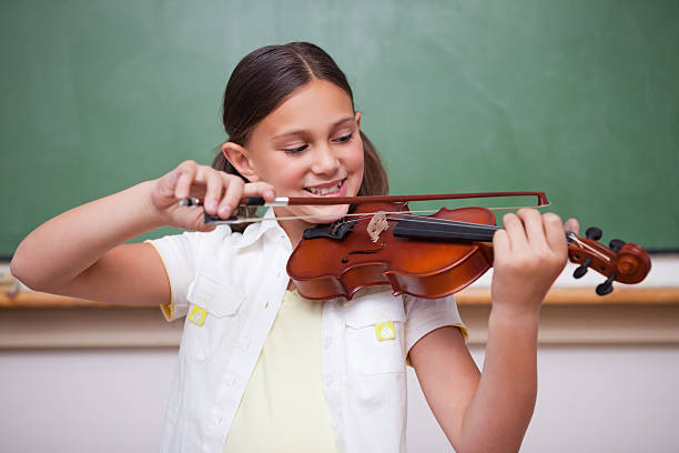 istock Schoolgirl playing the violin 177323821