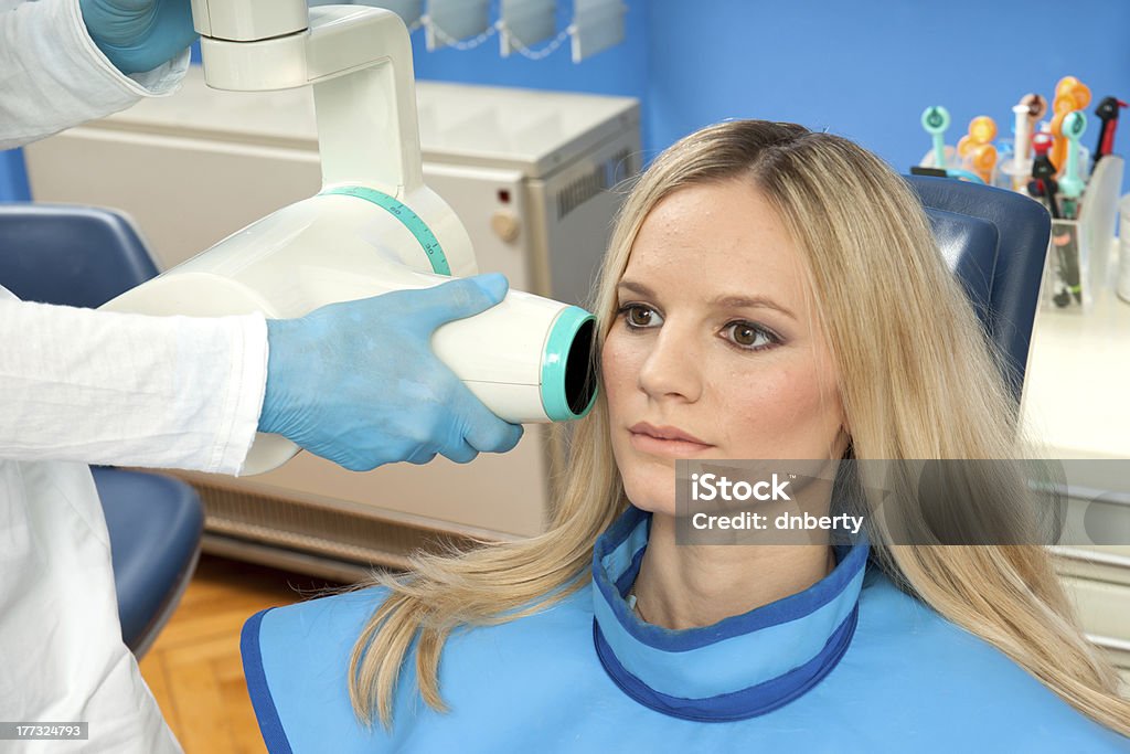 patient taking dental x-ray attractive woman patient at dentist taking x-ray exam Adult Stock Photo