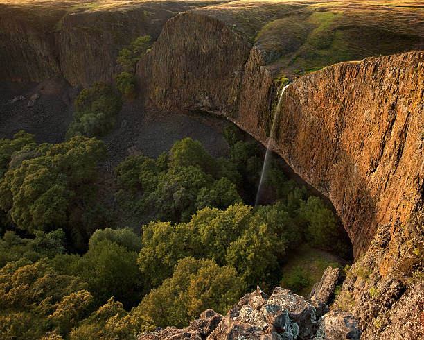 Bellissima cascata sulla scogliera al tramonto - foto stock