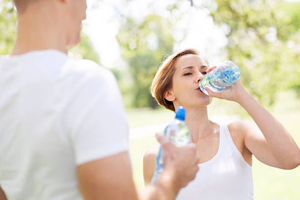 istock Woman drinking water after exercise 177325895