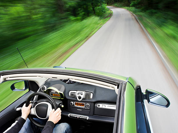 Driving electric car Motion blur shot of a man driving electric car on the mountain road and not polluting the airSee more car driving images in my portfolio alternative fuel vehicle stock pictures, royalty-free photos & images